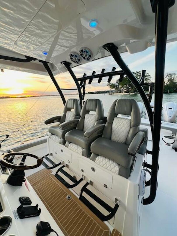 Regulator-41 2024-Fractional Ownership Available Stuart-2024 Regulator 41 boat interior with luxury seating, overlooking a serene sunset on the water.-5234050