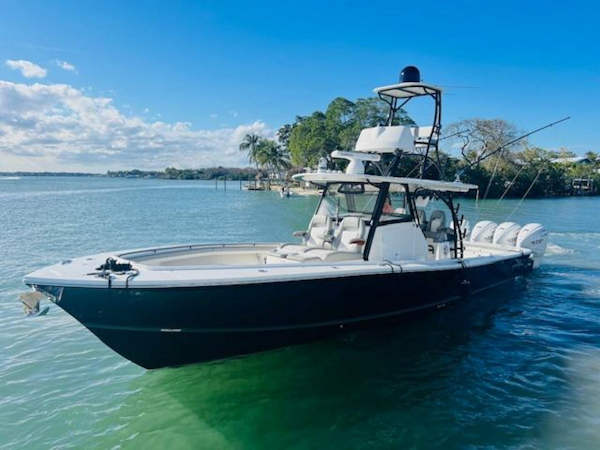 Regulator-41 2024-Fractional Ownership Available Stuart-2024 Regulator 41 boat on clear water, featuring sleek design and multiple outboard engines.-5234030