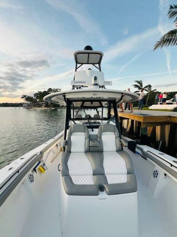 Regulator-41 2024-Fractional Ownership Available Stuart-2024 Regulator 41 boat with sleek seating, docked by a scenic waterfront.-5234046