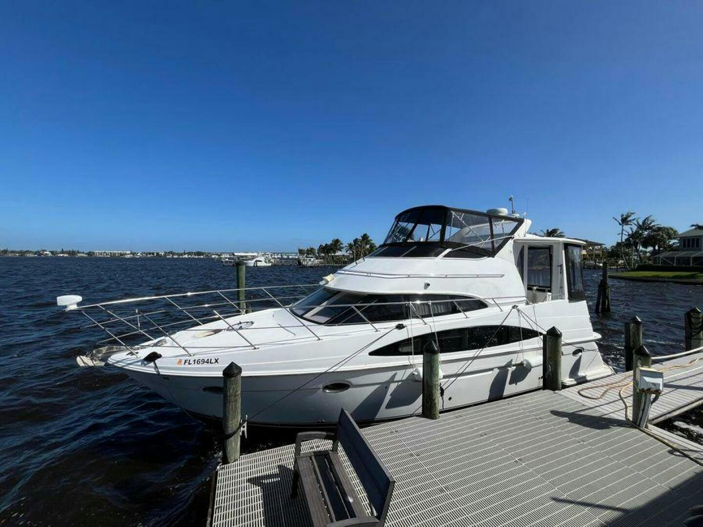 Carver-396 Motor Yacht 2000 -Stuart-2000 Carver 396 Motor Yacht docked by a scenic waterfront.-5234122
