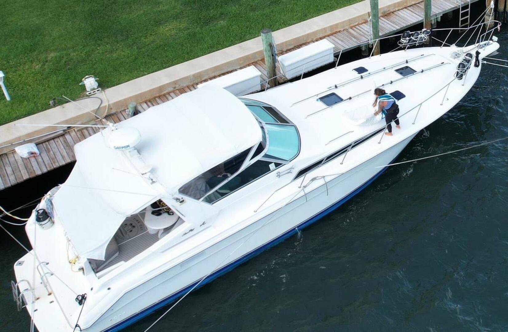 Sea Ray-440 Sundancer 1993 -Stuart-Aerial view of a 1993 Sea Ray 440 Sundancer yacht docked, with a person cleaning the deck.-5268560 | Thumbnail
