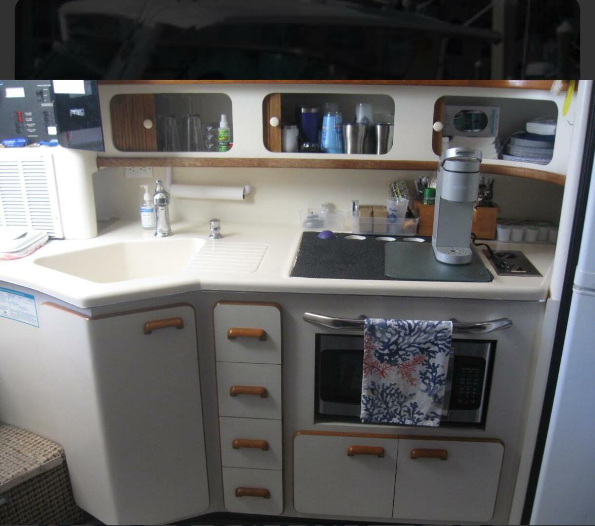 Sea Ray-440 Sundancer 1993 -Stuart-Interior of 1993 Sea Ray 440 Sundancer yacht kitchen with sink, stove, and storage.-5268573 | Thumbnail