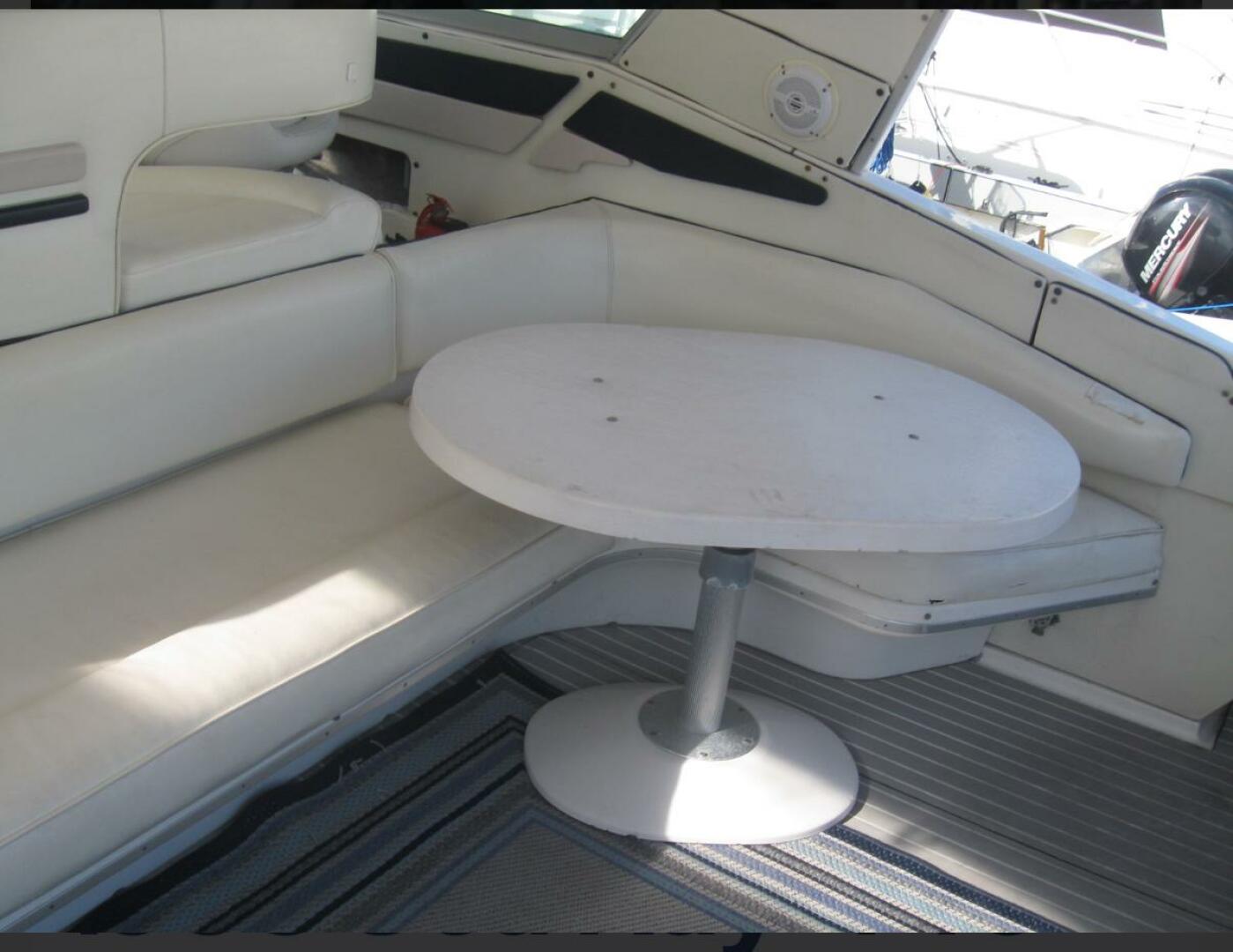 Sea Ray-440 Sundancer 1993 -Stuart-Interior seating area of 1993 Sea Ray 440 Sundancer with white table and cushioned seats.-5268565 | Thumbnail