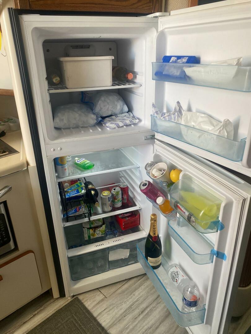 Sea Ray-440 Sundancer 1993 -Stuart-Open refrigerator in a 1993 Sea Ray 440 Sundancer, stocked with drinks and food items.-5268585 | Thumbnail