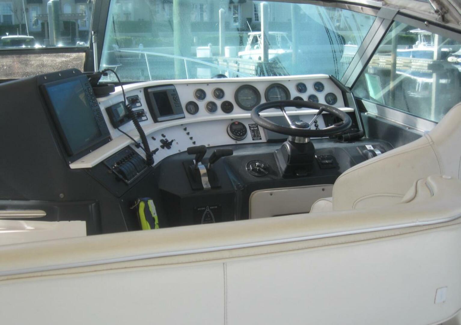 Sea Ray-440 Sundancer 1993 -Stuart-1993 Sea Ray 440 Sundancer helm with steering wheel and control panel.-5268564 | Thumbnail