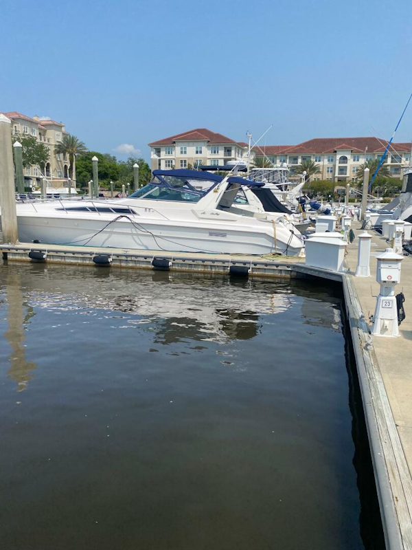 Sea Ray-440 Sundancer 1993 -Stuart-1993 Sea Ray 440 Sundancer docked at a marina with waterfront buildings in the background.-5402115