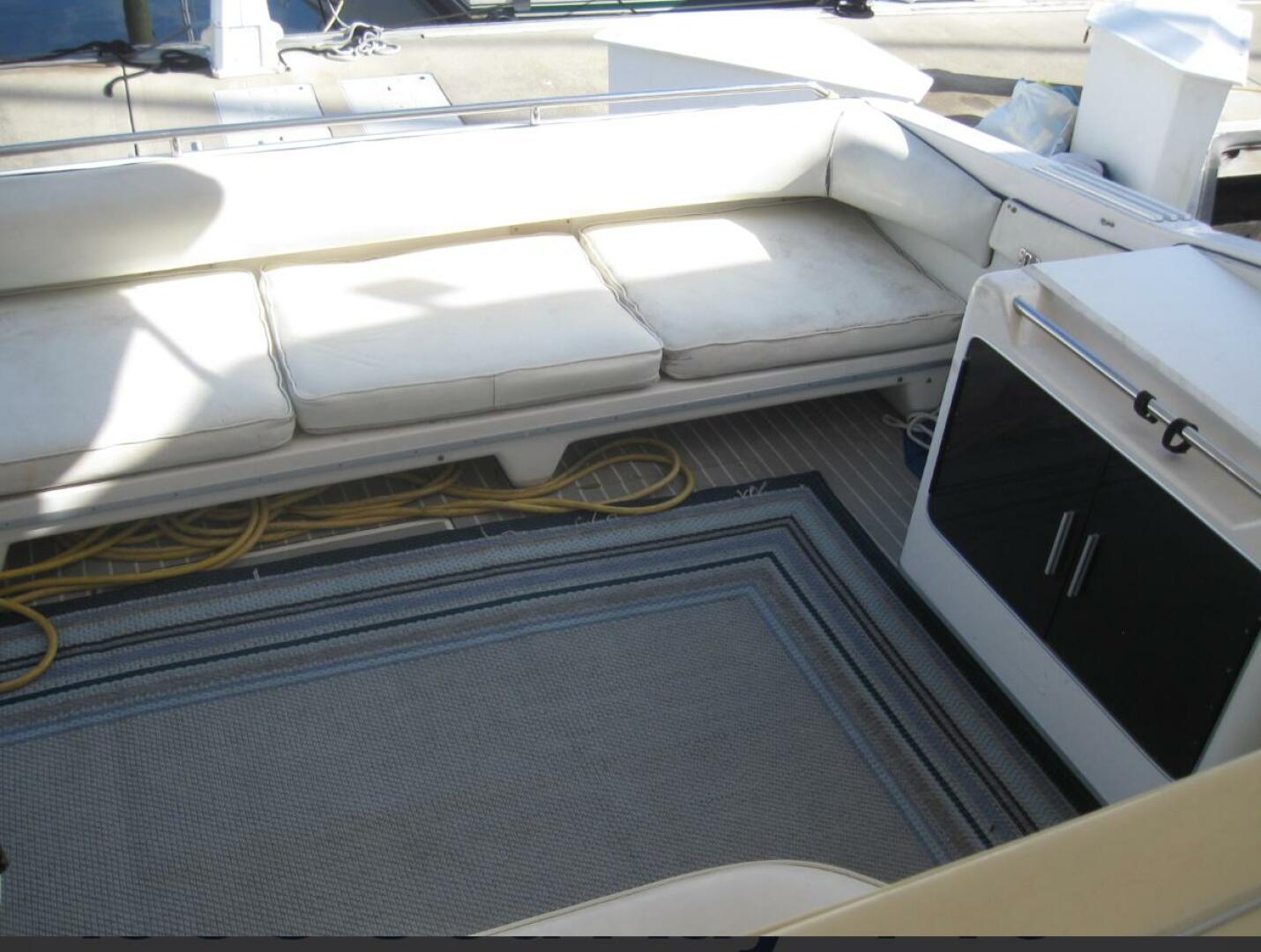 Sea Ray-440 Sundancer 1993 -Stuart-Interior seating area of a 1993 Sea Ray 440 Sundancer yacht with cushions and storage.-5268566 | Thumbnail