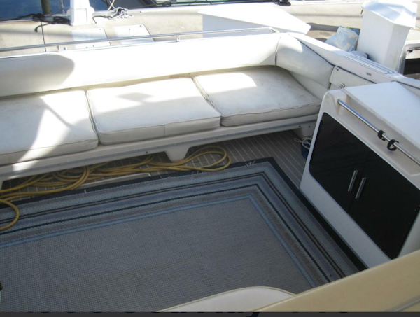 Sea Ray-440 Sundancer 1993 -Stuart-Interior seating area of a 1993 Sea Ray 440 Sundancer yacht with cushions and storage.-5268566