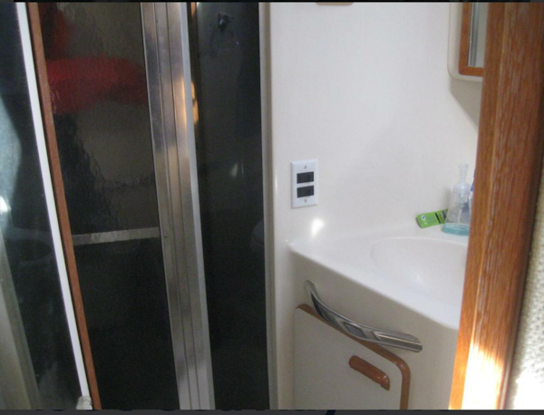 Sea Ray-440 Sundancer 1993 -Stuart-Bathroom interior of 1993 Sea Ray 440 Sundancer yacht, featuring sink and shower.-5268579
