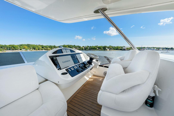 Sunseeker-Manhattan 65 2016 -Stuart-2016 Sunseeker Manhattan 65 yacht helm with white seating and navigation controls, overlooking water.-5314544