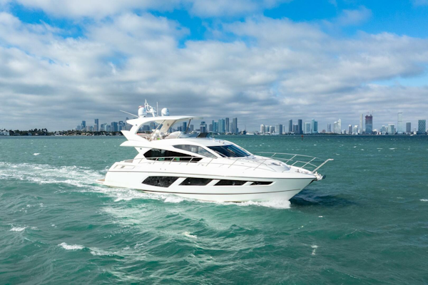 Sunseeker-Manhattan 65 2016 -Stuart-2016 Sunseeker Manhattan 65 yacht cruising on open water with city skyline backdrop.-5314538