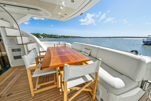 Sunseeker-Manhattan 65 2016 -Stuart-Luxurious Sunseeker Manhattan 65 yacht deck with seating, table, and scenic water view.-5314563