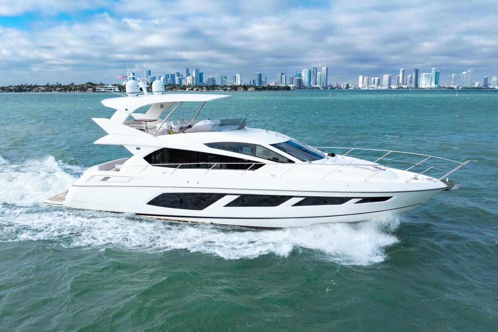 Sunseeker-Manhattan 65 2016 -Stuart-2016 Sunseeker Manhattan 65 yacht cruising on open water with city skyline backdrop.-5314521 | Thumbnail