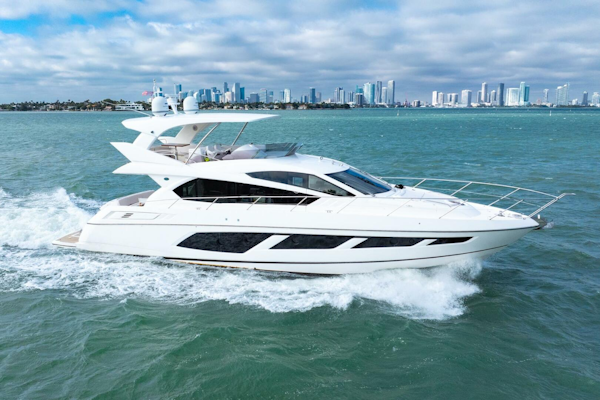 Sunseeker-Manhattan 65 2016 -Stuart-2016 Sunseeker Manhattan 65 yacht cruising on open water with city skyline backdrop.-5314521