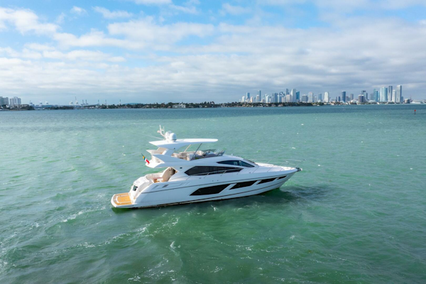 Sunseeker-Manhattan 65 2016 -Stuart-2016 Sunseeker Manhattan 65 yacht cruising on open water with city skyline backdrop.-5314515