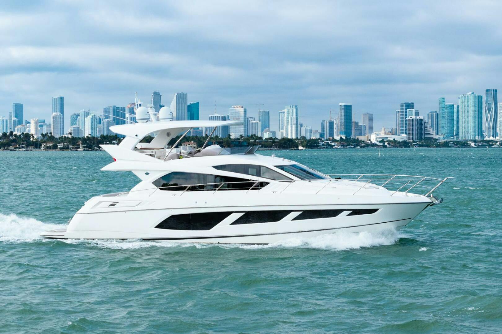 Sunseeker-Manhattan 65 2016 -Stuart-2016 Sunseeker Manhattan 65 yacht cruising with city skyline in the background.-5314524