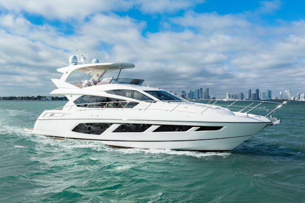 Sunseeker-Manhattan 65 2016 -Stuart-2016 Sunseeker Manhattan 65 yacht cruising on open water with city skyline backdrop.-5314541