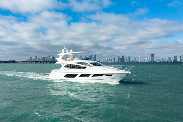 Sunseeker-Manhattan 65 2016 -Stuart-2016 Sunseeker Manhattan 65 yacht cruising on open water with city skyline backdrop.-5314539
