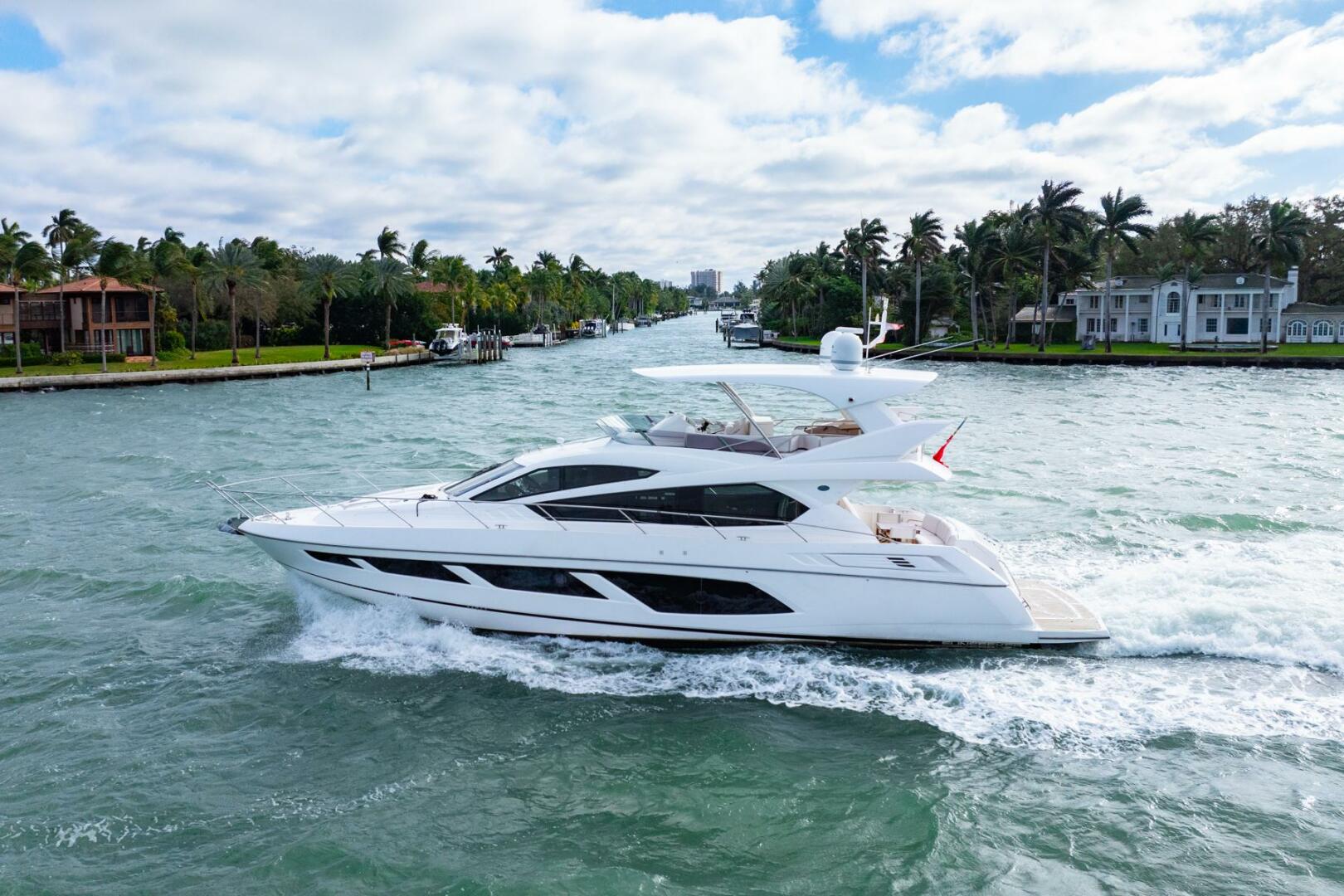 Sunseeker-Manhattan 65 2016 -Stuart-2016 Sunseeker Manhattan 65 yacht cruising on a scenic waterway with palm trees.-5314520 | Thumbnail