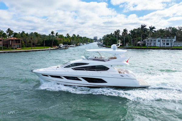 Sunseeker-Manhattan 65 2016 -Stuart-2016 Sunseeker Manhattan 65 yacht cruising on a scenic waterway with palm trees.-5314520