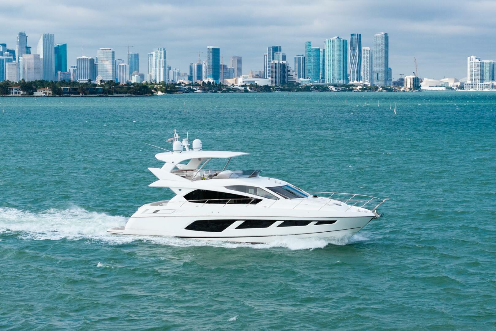 Sunseeker-Manhattan 65 2016 -Stuart-2016 Sunseeker Manhattan 65 yacht cruising near a city skyline.-5314526 | Thumbnail