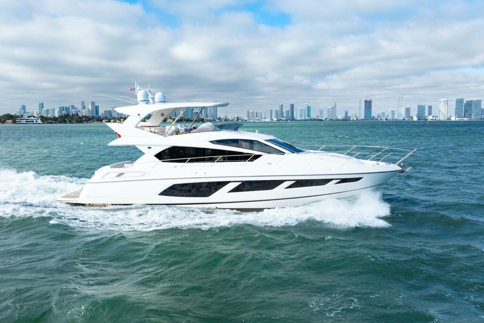 Sunseeker-Manhattan 65 2016 -Stuart-2016 Sunseeker Manhattan 65 yacht cruising on open water with city skyline backdrop.-5314532 | Thumbnail