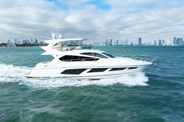 Sunseeker-Manhattan 65 2016 -Stuart-2016 Sunseeker Manhattan 65 yacht cruising on open water with city skyline backdrop.-5314532