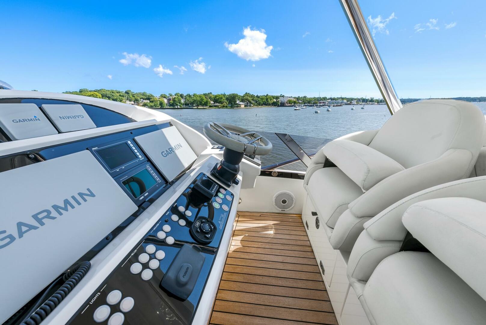 Sunseeker-Manhattan 65 2016 -Stuart-2016 Sunseeker Manhattan 65 yacht helm with Garmin navigation, overlooking serene waters.-5314546 | Thumbnail