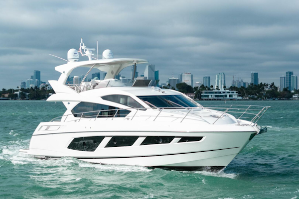 Sunseeker-Manhattan 65 2016 -Stuart-2016 Sunseeker Manhattan 65 yacht cruising on open water with city skyline backdrop.-5314531
