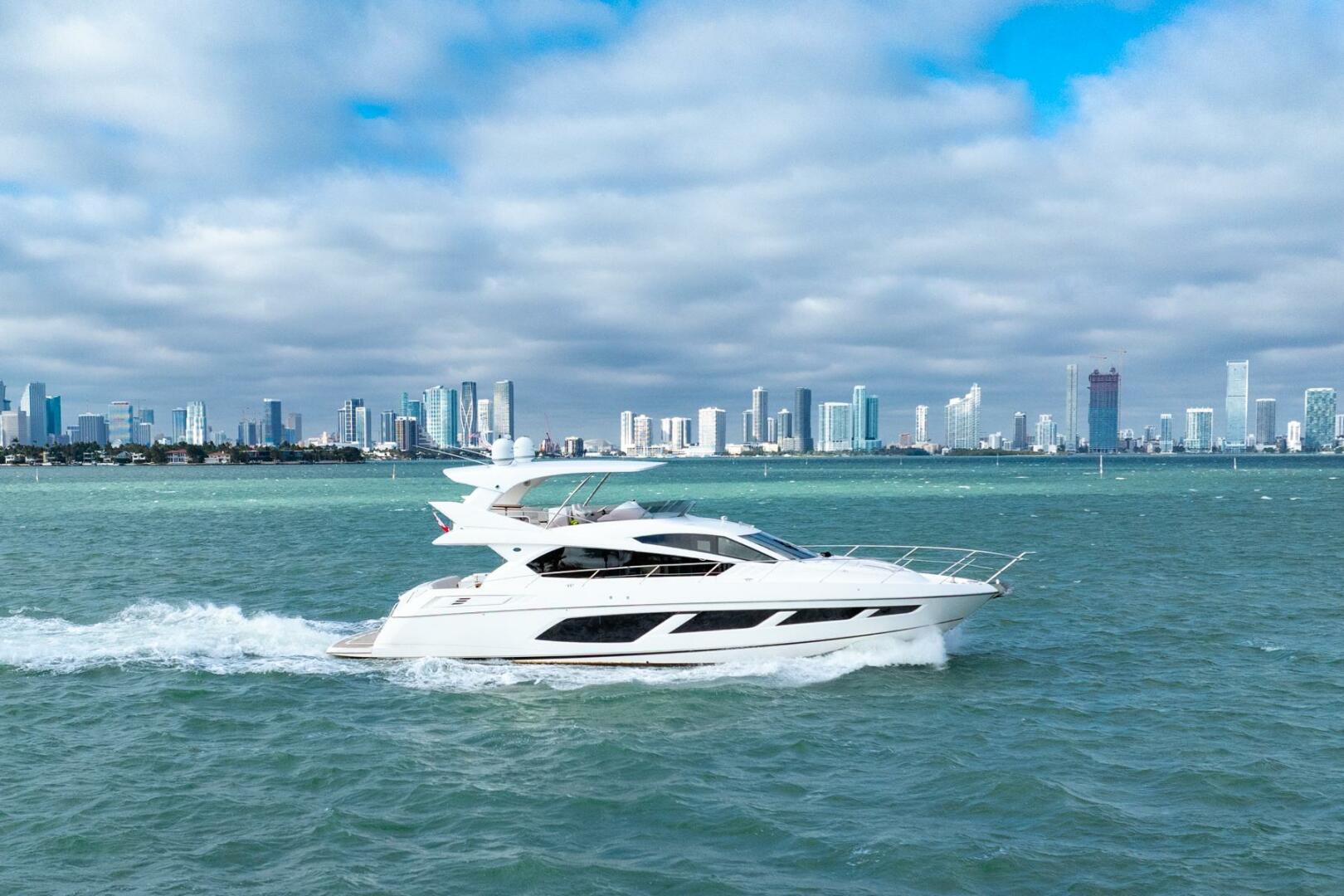 Sunseeker-Manhattan 65 2016 -Stuart-2016 Sunseeker Manhattan 65 yacht cruising near city skyline.-5314522 | Thumbnail
