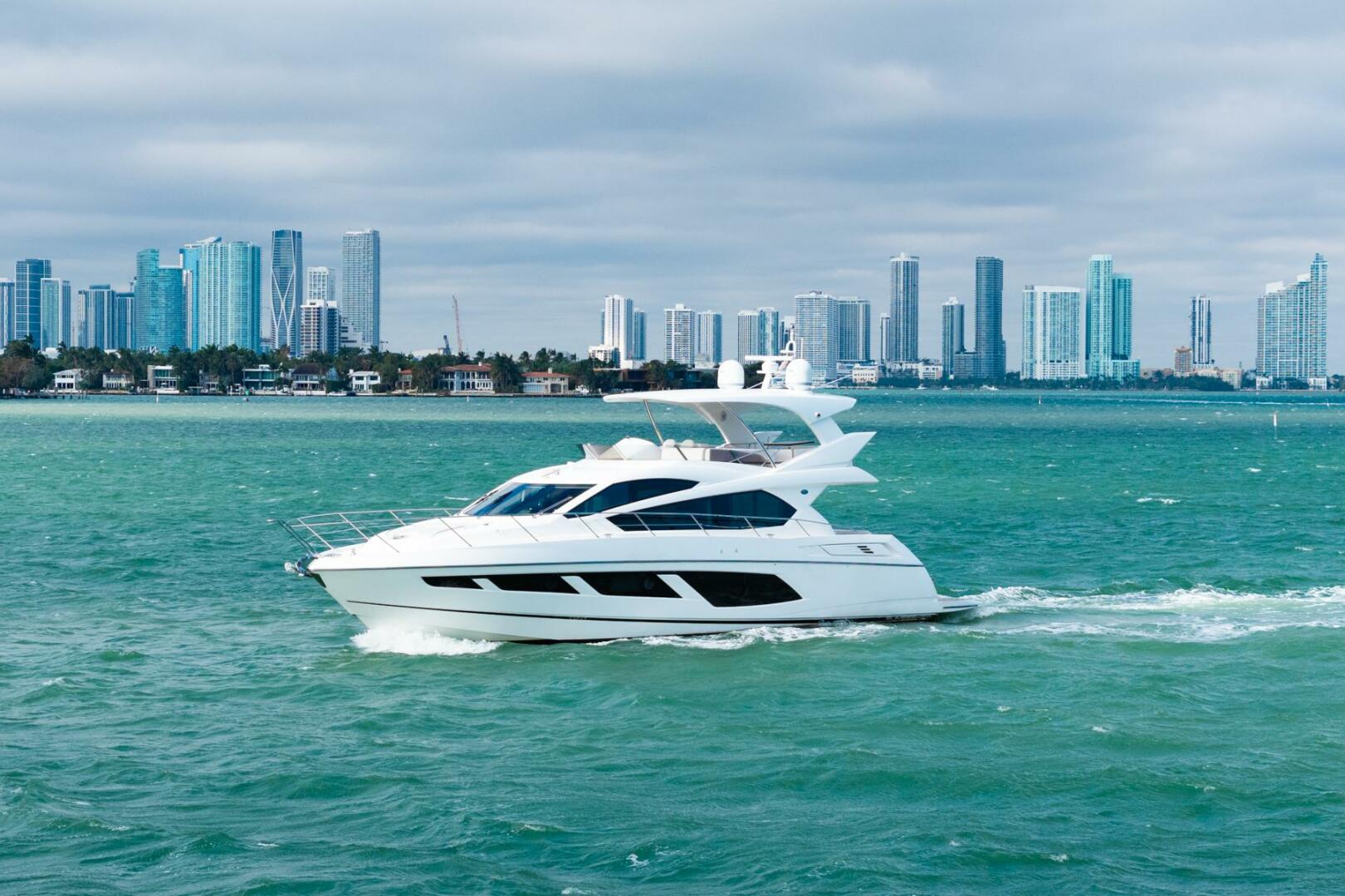 Sunseeker-Manhattan 65 2016 -Stuart-2016 Sunseeker Manhattan 65 yacht cruising near a city skyline.-5314528 | Thumbnail