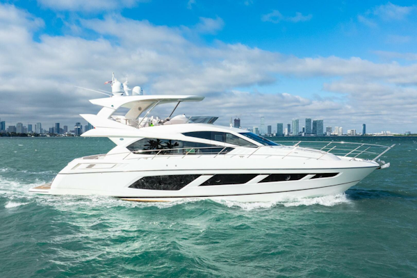 Sunseeker-Manhattan 65 2016 -Stuart-2016 Sunseeker Manhattan 65 yacht cruising on open water with city skyline backdrop.-5314540