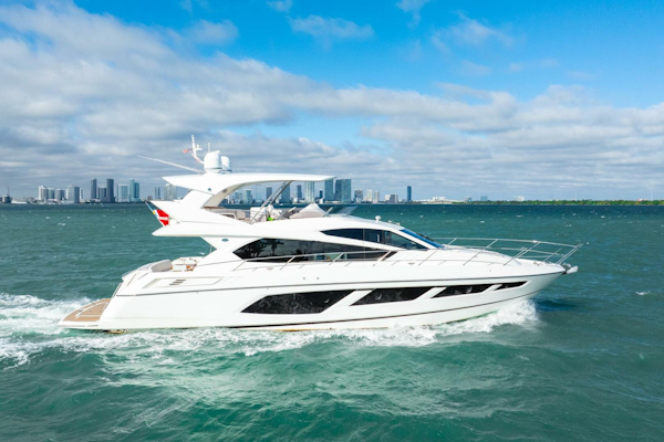 Sunseeker-Manhattan 65 2016 -Stuart-2016 Sunseeker Manhattan 65 yacht cruising on open water with city skyline backdrop.-5314537