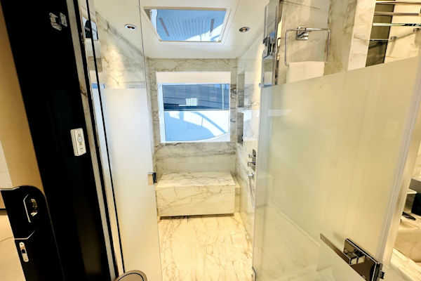 Majesty Yachts-120 2024-Optimism Stuart-Florida-United States-Luxurious marble bathroom in 2023 Majesty 120 yacht, featuring modern fixtures and natural light.-5695601